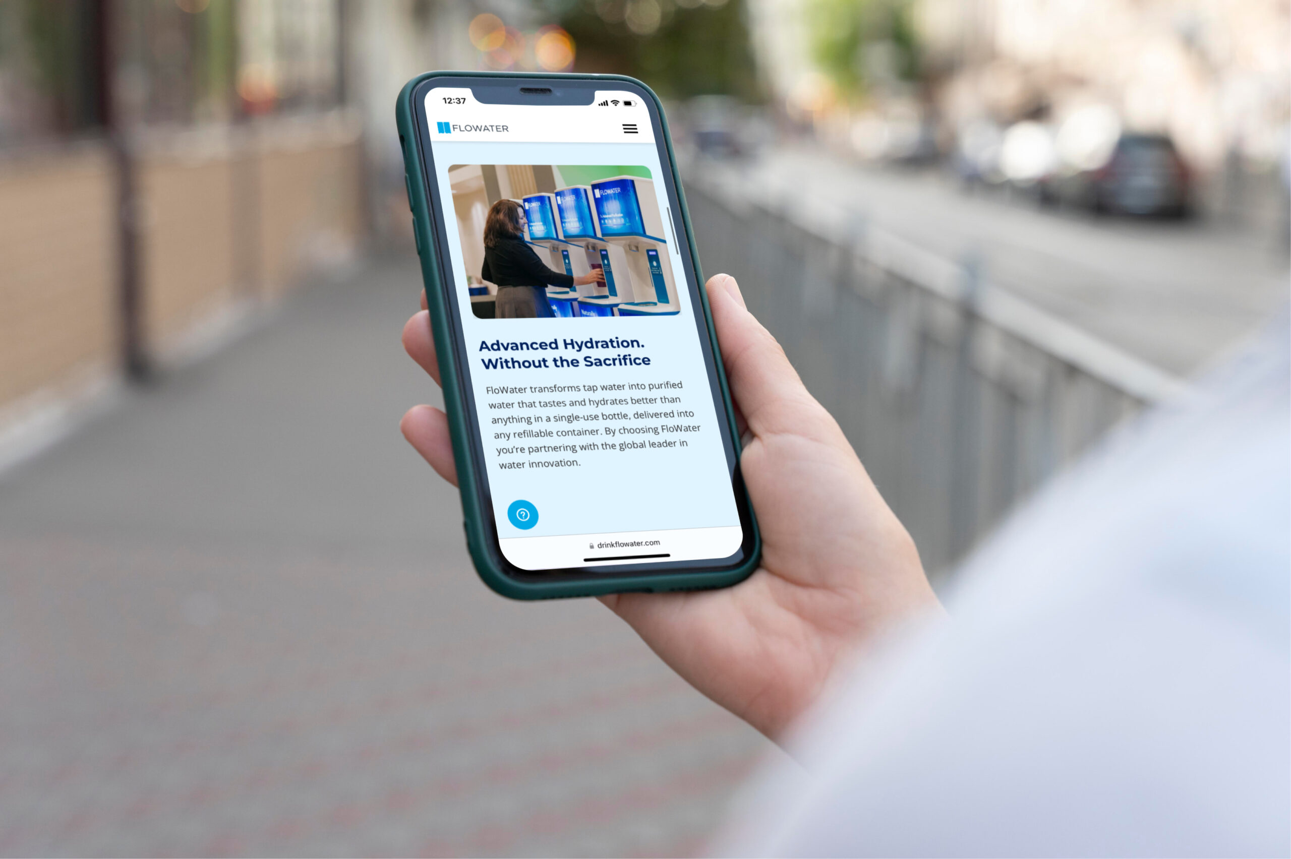 person holding phone with flowater website on it