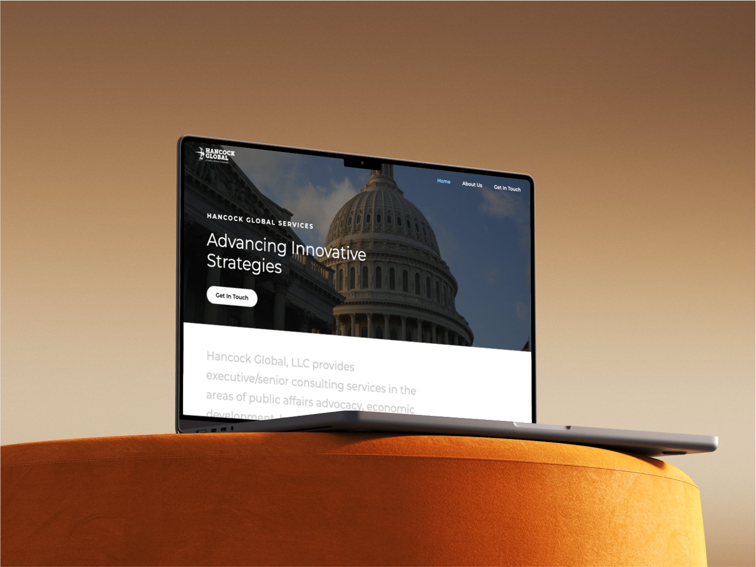 laptop on a chair showing the hancock global website