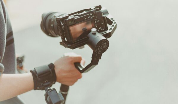 video production person holding camera and a gimble